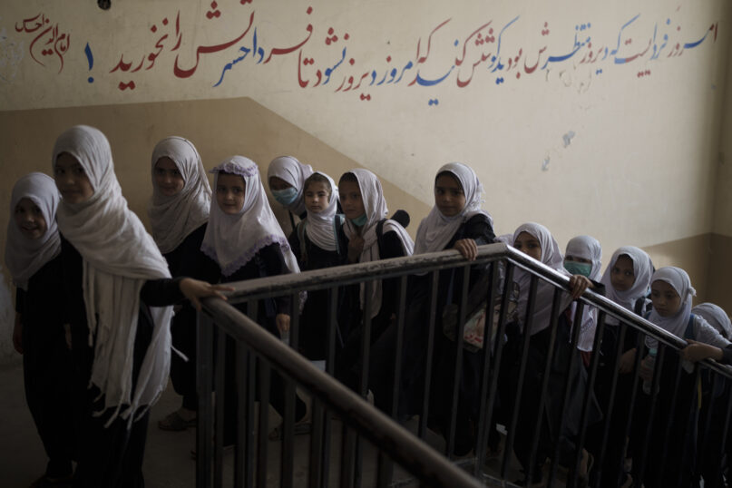 Girls walk upstairs as they enter a school before class in Kabul, Afghanistan, on Sept. 12, 2021. (AP Photo/Felipe Dana)