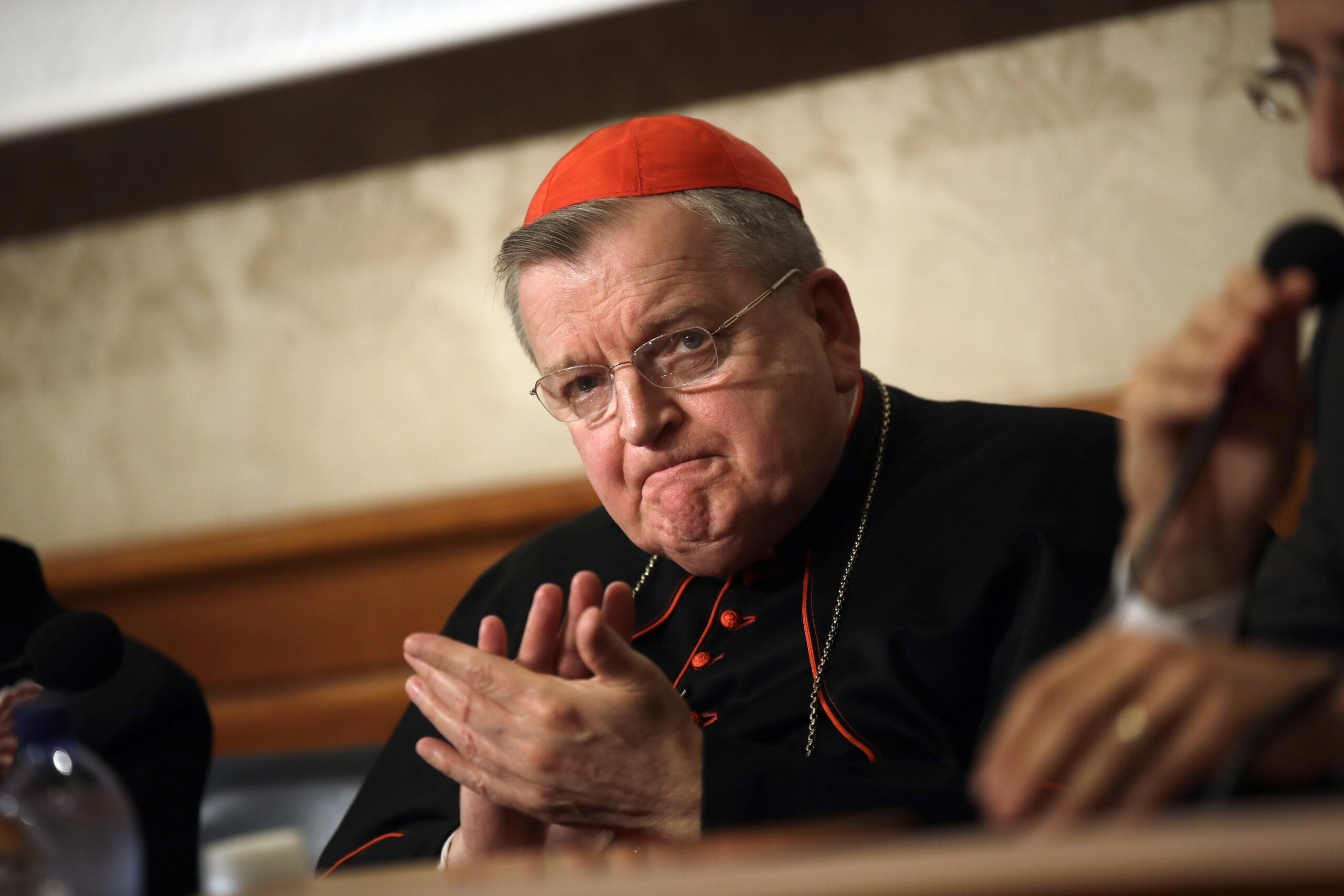 FILE - In this Sept. 6, 2018 file photo, Cardinal Raymond Burke applauds during a news conference at the Italian Senate, in Rome. Burke, a high-ranking Roman Catholic cardinal who was placed on a ventilator after contracting COVID-19 said he has moved into a house but is still struggling to recover from the disease. (AP Photo/Alessandra Tarantino, File)