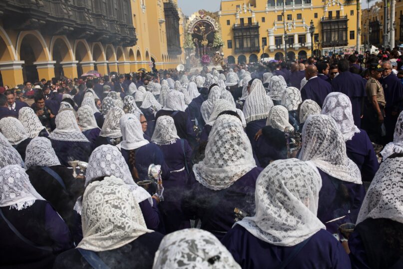 FILE - In this March 30, 2018 file photo, women, their heads covered by veils, burn incense as they accompany the Good Friday procession, in Lima, Peru. The Lord Of Miracles procession has been canceled for the second straight year because of the coronavirus pandemic, the archbishopric of Lima announced Tuesday, Sept. 28, 2021. (AP Photo/Rodrigo Abd, File)
