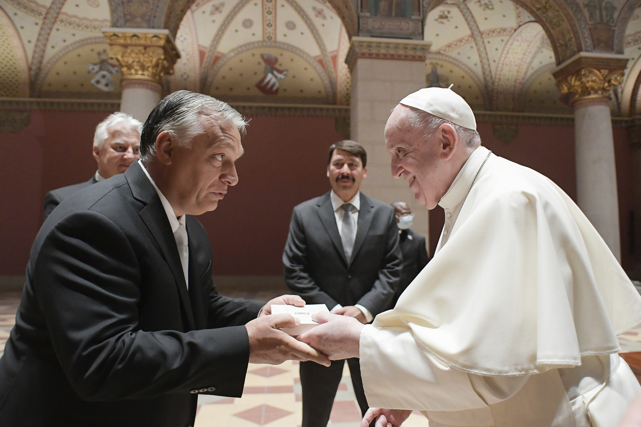 Pope Francis exchanges gifts with Hungarian Prime Minister Viktor Orban, at Budapest's Museum of Fine Arts, Sunday, Sept. 12, 2021. Francis is opening his first foreign trip since undergoing major intestinal surgery in July, embarking on an intense, four-day, two-nation trip to Hungary and Slovakia that he has admitted might be overdoing it. (Vatican Media via AP)