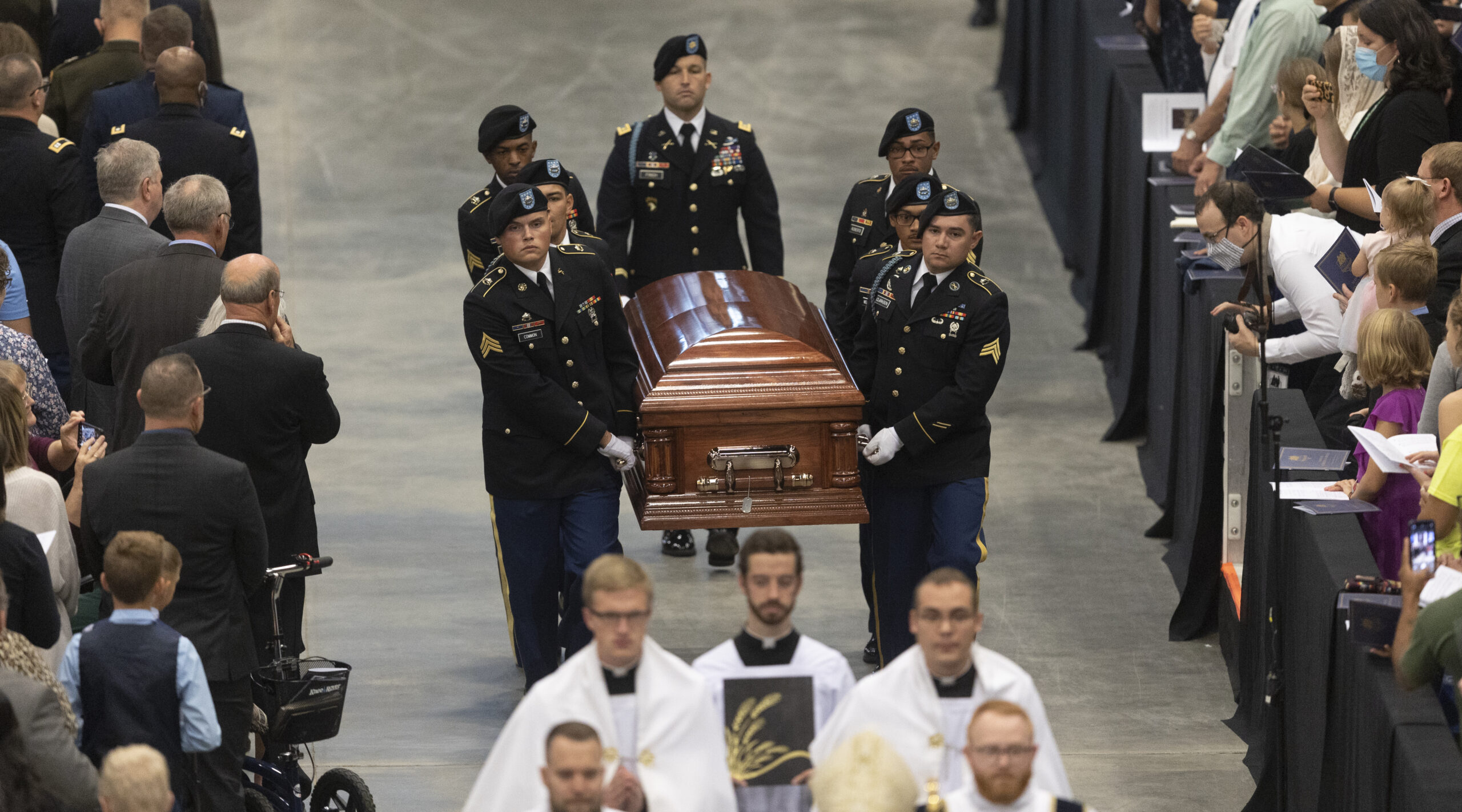 A Fort Riley honor guard carries the remains of Father Emil to an altar during Kapaun's funeral Mass on Wednesday, Sept. 29, 2021, in Wichita, Kan. Kapaun died in a North Korean POW camp in May of 1951. He was posthumously awarded the Medal of Honor in 2013 for his bravery in the Korean War. Kapaun's remains were identified earlier this year and returned home to Kansas recently. (Travis Heying/The Wichita Eagle via AP)