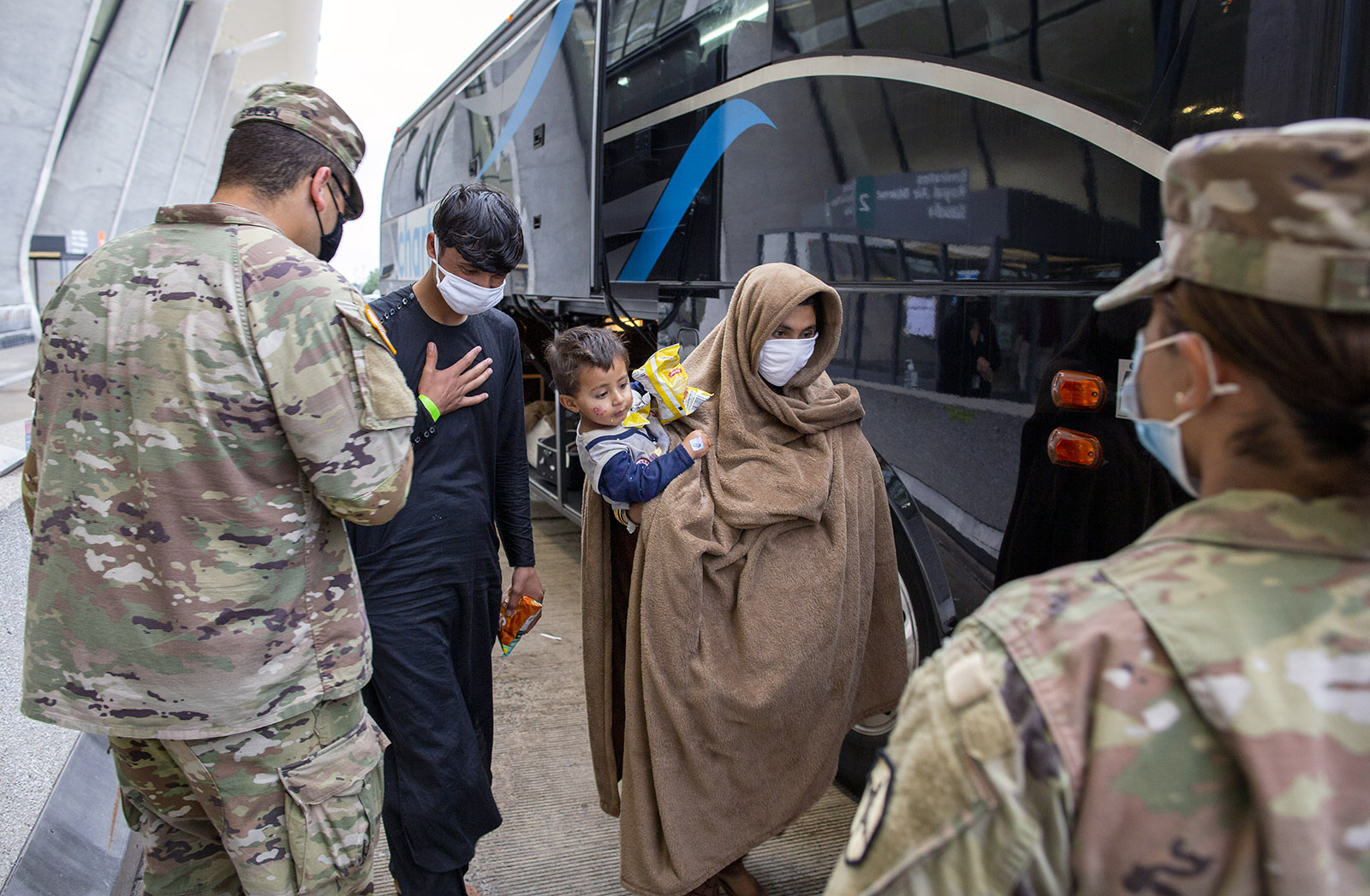 People evacuated from Kabul, Afghanistan, are greeted by U.S. service members at Washington Dulles International Airport, in Chantilly, Virginia, on Sept. 1, 2021. (AP Photo/Gemunu Amarasinghe)