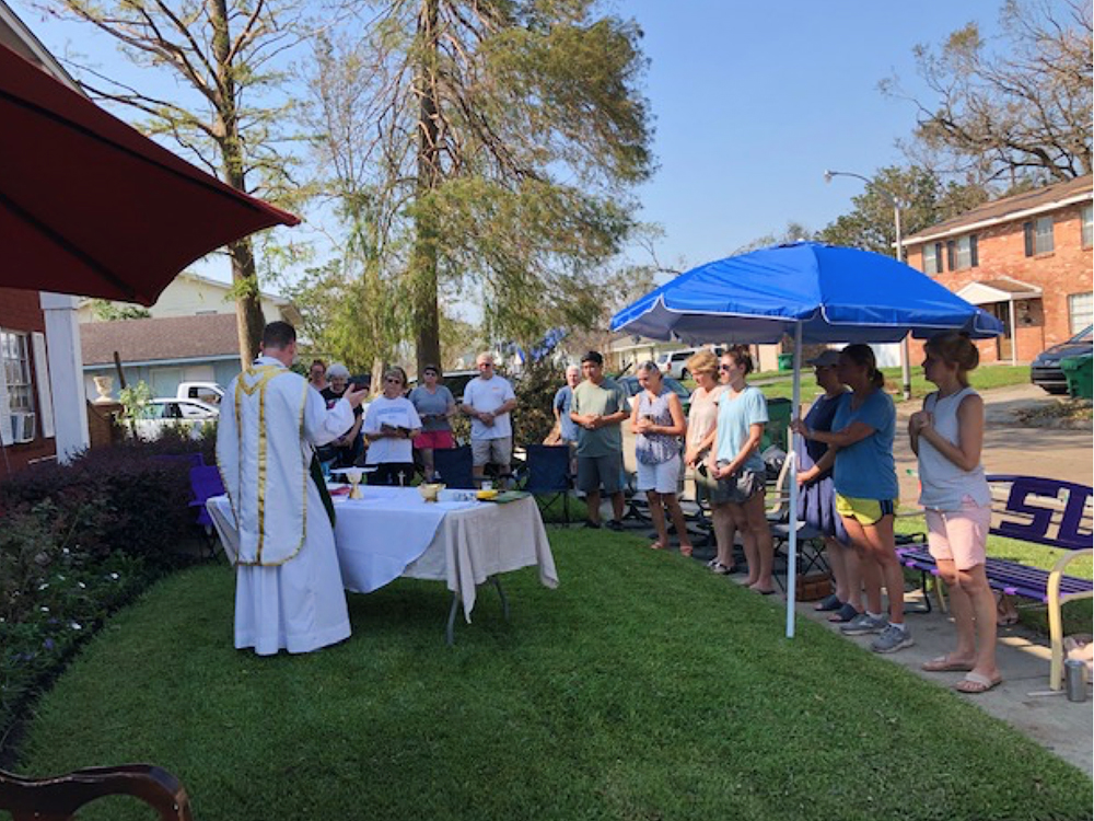 The Rev. David Ducote, pastor of St. Joan of Arc, holds Mass in a parishoner’s yard in LaPace, Louisiana, following Hurricane Ida. Photo courtesy of the Rev. David Ducote