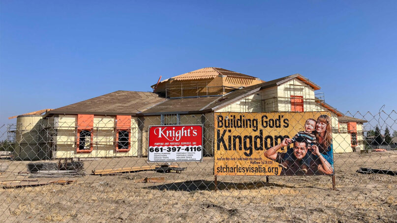 A sign reads “Building God’s Kingdom” at the St. Charles Borromeo Catholic Church construction site in Visalia, California, Aug. 26, 2021. RNS photo by Alejandra Molina