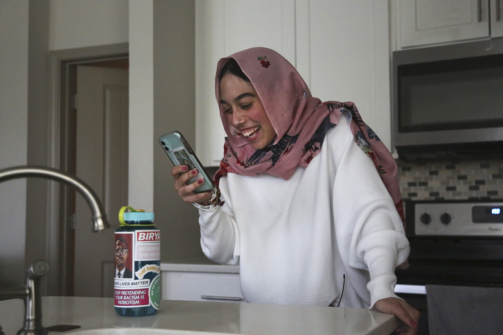 Amirah Ahmed, 17, video chats with a friend from her home in Fredericksburg, Va., on Saturday, Aug. 14, 2021. (AP Photo/Jessie Wardarski)