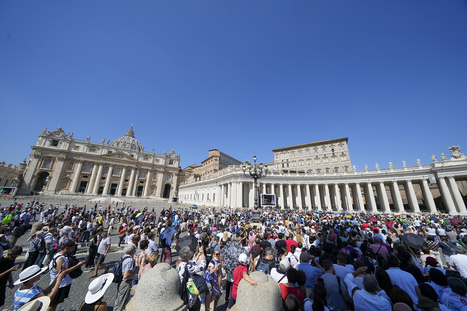 People crowd St. Peter's Square, at the Vatican, as Pope Francis recites the Angelus noon prayer from the window of his studio, Sunday, Sept. 5, 2021. (AP Photo/Andrew Medichini)