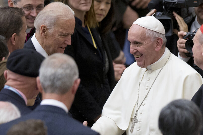 In this April 29, 2016, file photo, Pope Francis shakes hands with then-U.S. Vice President Joe Biden as he takes part in a congress on the progress of regenerative medicine and its cultural impact, held in the Pope Paul VI Hall at the Vatican. (AP Photo/Andrew Medichini, File)