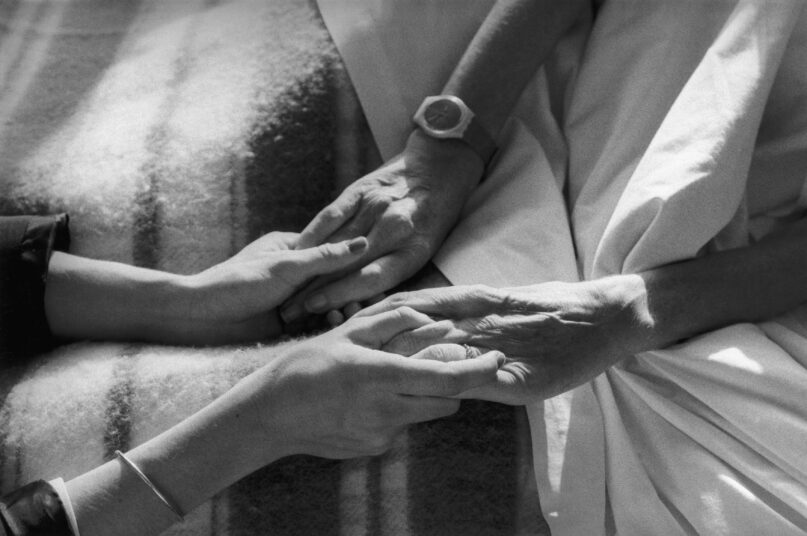 Physical touch at the end of life has a special significance in many cultures and offers solace. (Valerie Winckler/Gamma-Rapho via Getty Images)