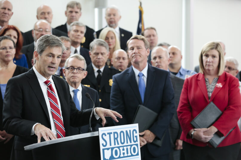 FILE - In this Oct. 7, 2019 file photo, Ohio Sen. Matt Dolan, left, speaks during a news conference at the Ohio Department of Public Safety in Columbus, Ohio. Dolan, the lone Republican moderate at a U.S. Senate candidate forum in Ohio on Sunday, Oct. 24, 2021, said at one point he felt 