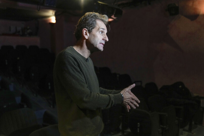 Author and actor Laurent Martinez gestures as he speaks during an interview with The Associated-Press at 