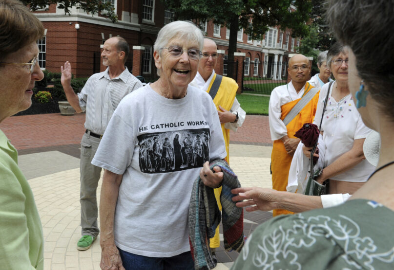 FILE - In this Aug. 9, 2012, file photo, Sister Megan Rice, center, and Michael Walli, in the background waving, are greeted by supporters as they arrive for a federal court appearance in Knoxville, Tenn., after being charged with sabotaging a government nuclear complex. Rice, who served two years in prison and was released when her original conviction was thrown out by a federal appeals court, died of congestive heart failure Oct. 10, 2021, at Holy Child Center in Rosemont, Pa. She was 91. (Michael Patrick/Knoxville News Sentinel via AP, File)