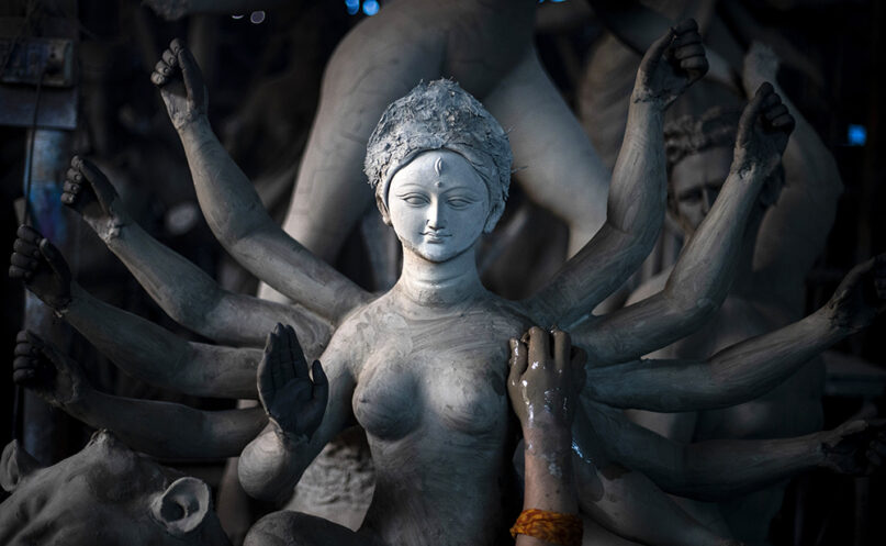 An artisan works on a clay statue of Hindu goddess Durga ahead of Durga Puja festival in Gauhati, India, Oct. 1, 2021. (AP Photo/Anupam Nath)