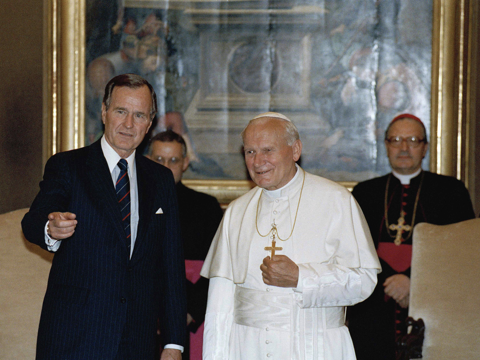 FILE - In this May 27, 1989, file photo, President George H. W. Bush gestures while standing with Pope John Paul II in the papal library at the Vatican. (AP Photo/Ron Edmonds, File)