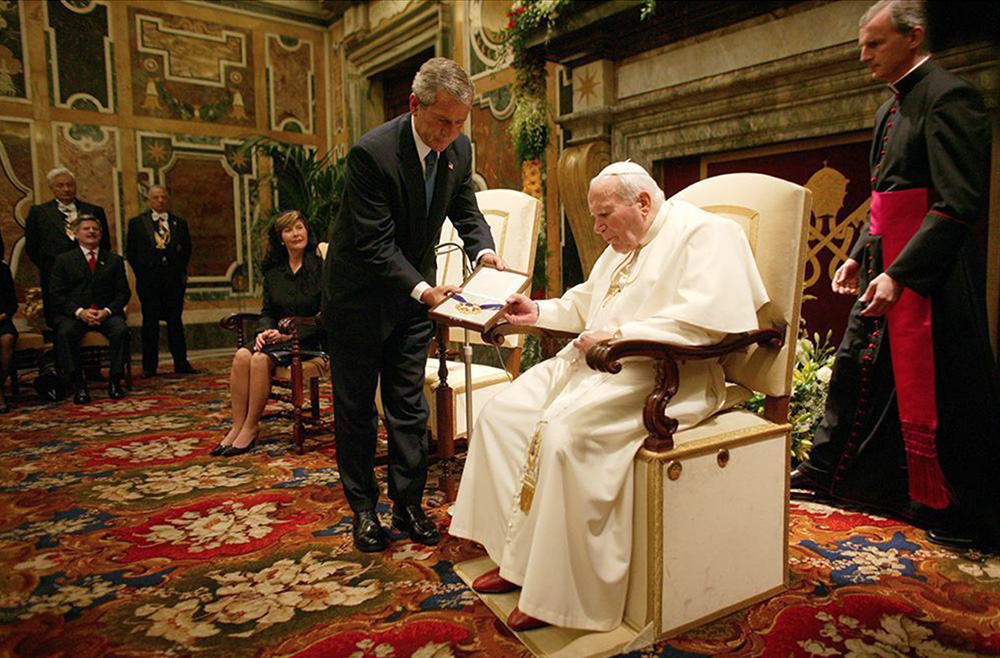 President George W. Bush presents the Medal of Freedom to Pope John Paul II during a visit to the Vatican in Rome on June 4, 2004. White House photo by Eric Draper