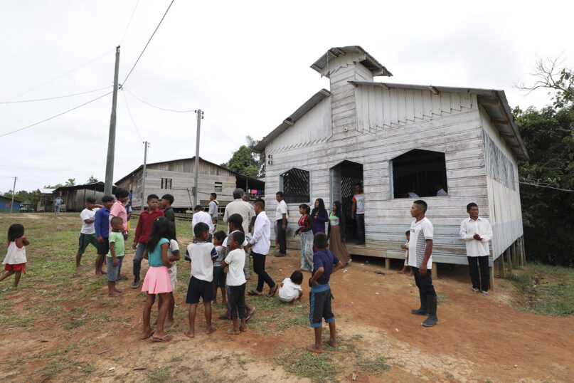 Residents gather outside the Catholic church of Novo Cruzador, Brazil, after attending a prayer led by missionary Antelmo Pereira on Sept. 22, 2019. (AP Photo/Fernando Vergara, File)