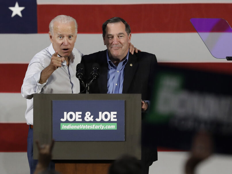 Former Vice President Joe Biden, left, and Democratic Sen. Joe Donnelly speak during a rally, Friday, Oct. 12, 2018, in Hammond, Ind. (AP Photo/Darron Cummings)