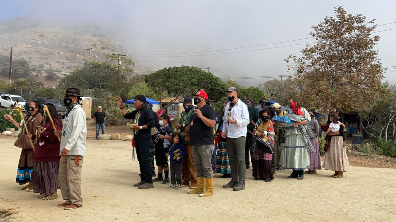 Apache Stronghold, a coalition of Apaches, other Native peoples and non-Native supporters seeking to preserve Oak Flat, arrives at Wishtoyo Chumash Village to begin a ceremonial circle, Sunday, Oct. 17, 2021, in Malibu, California. RNS photo by Alejandra Molina