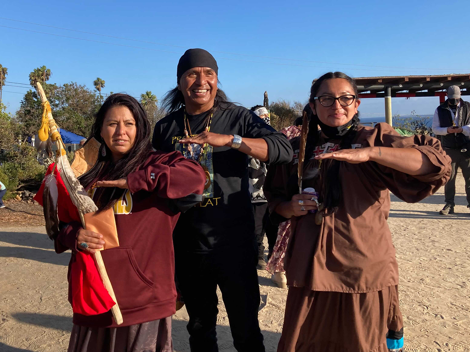 Wendsler Nosie Sr., center, with his daughters at Wishtoyo Chumash Village in Malibu, California, Sunday, Oct. 17, 2021. RNS photo by Alejandra Molina