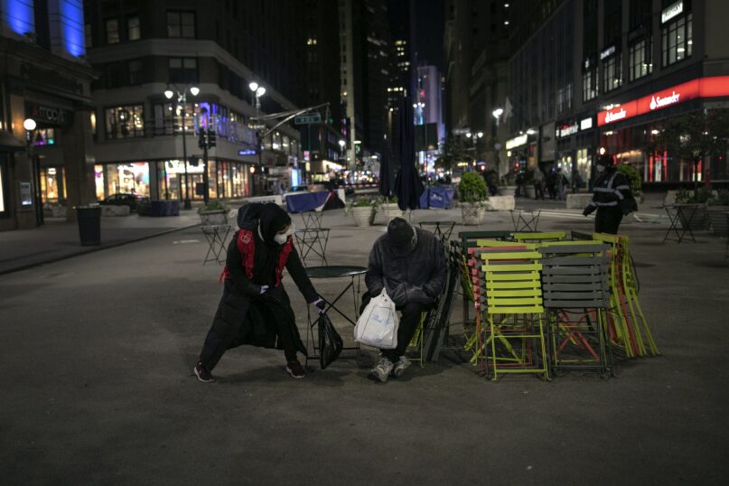 A Muslims Giving Back volunteer delivers warm food to a homeless man in New York City in April 2020. (P Photo/Wong Maye-E)