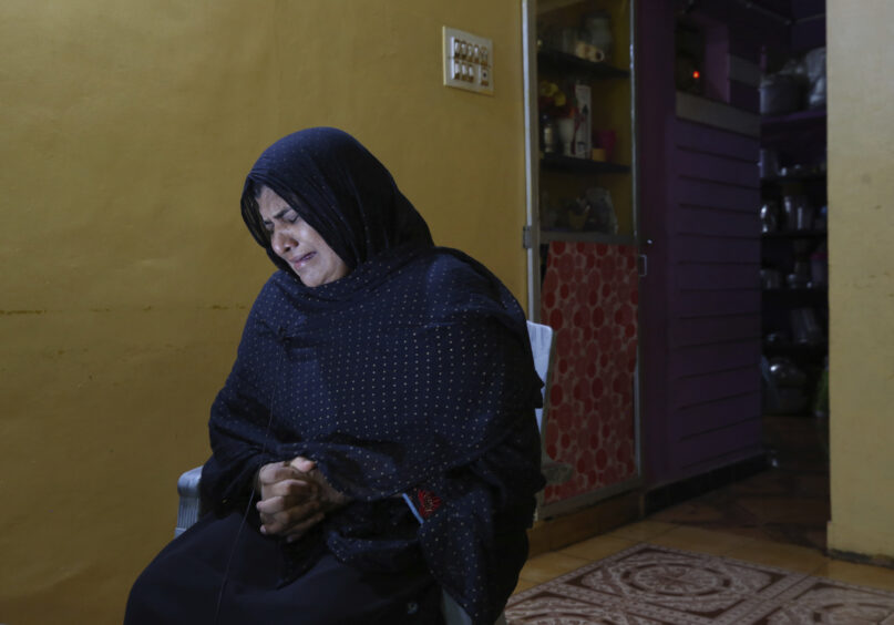 Nazima Shaikh, mother of Arbaz Mullah weeps as she speaks to the Associated Press at her home in Belagavi, India, Oct. 6, 2021. Arbaz Mullah was a Muslim man in love with a Hindu woman. But the romance so angered the woman’s family that — according to police — they hired members of a hard-line Hindu group to murder him. It's a grim illustration of the risks facing interfaith couples as Hindu nationalism surges in India. (AP Photo/Aijaz Rahi)