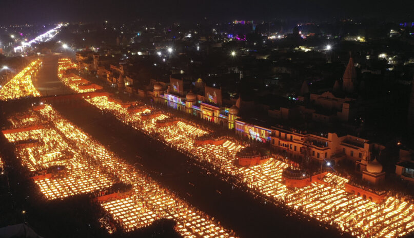 People light earthen lamps on the banks of the Saryu River in Ayodhya, India, Nov. 3, 2021. Over 900,000 earthen lamps were lit and were kept burning for 45 minutes as the north Indian city of Ayodhya retained its Guinness World Record for lighting oil lamps as part of the Diwali celebration — the Hindu festival of lights. (AP Photo/Rajesh Kumar Singh)