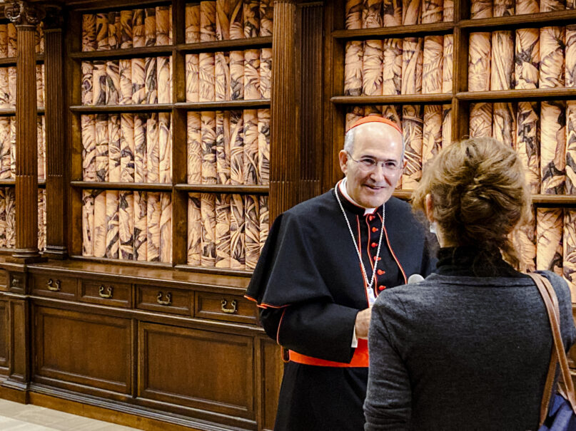 The Vatican Apostolic Librarian, Cardinal José Tolentino de Mendonça, left, speaks to a journalist, Monday, Nov. 8, 202, during the presentation to the media of the exhibition 