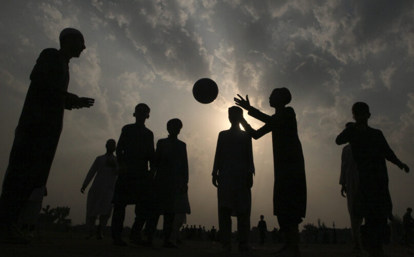 Students of an Islamic seminary play with soccer ball in Peshawar, the capital of Pakistan's northwest Khyber Pakhtunkhwa province bordering Afghanistan, Sunday, Oct. 10, 2021. Wahab, the youngest son of four from a wealthy Pakistani family was rescued by his uncle, from a Taliban training camp on Pakistan’s border with Afghanistan earlier this year. His uncle blamed his slide to radicalization on the neighborhood teens Wahab socialized with in their northwest Pakistan hometown, plus video games and Internet sites his friends introduced to him. (AP Photo/Muhammad Sajjad)