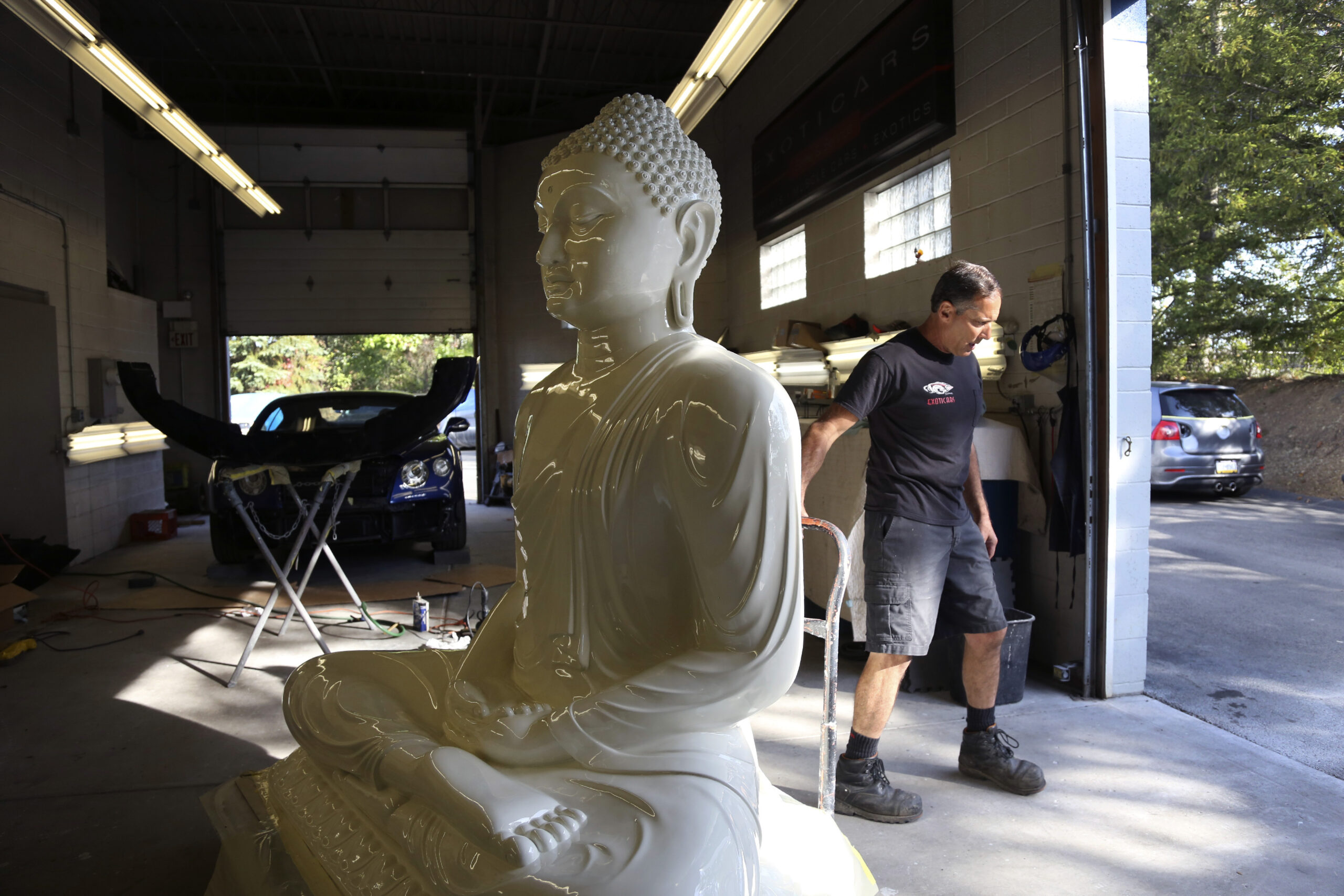 Bentleys to Buddhas: Vintage-car shop restores temple statue