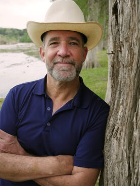 Matthew Dowd poses by the Blanco River in Wimberley, Texas. Courtesy photo