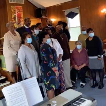 Congregants pose for a photo with the Rev. Ratona Stokes-Robinson after her first service inside St. James African Methodist Episcopal Church in Thorofare, New Jersey. Video screengrab