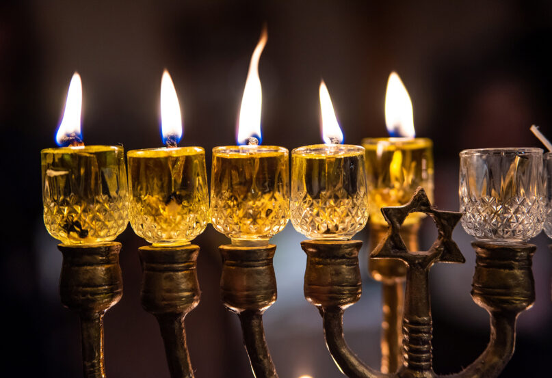 Candles are lit on a menorah during Hanukkah. Photo by Evgeni Tcherkasski/Pixabay/Creative Commons