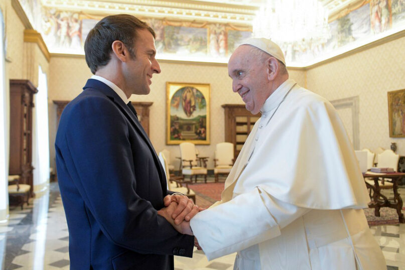 Pope Francis shakes hands with French President Emmanuel Macron during a meeting at the Vatican, November 26, 2021. Photo by Vatican Media