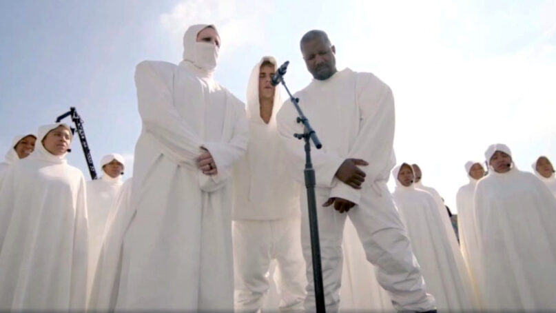 Musicians Marilyn Manson, from left, Justin Bieber and Ye (who changed his name from Kanye West), surrounded by a choir, during a Sunday Service event, Oct. 31, 2021. Video screen grab