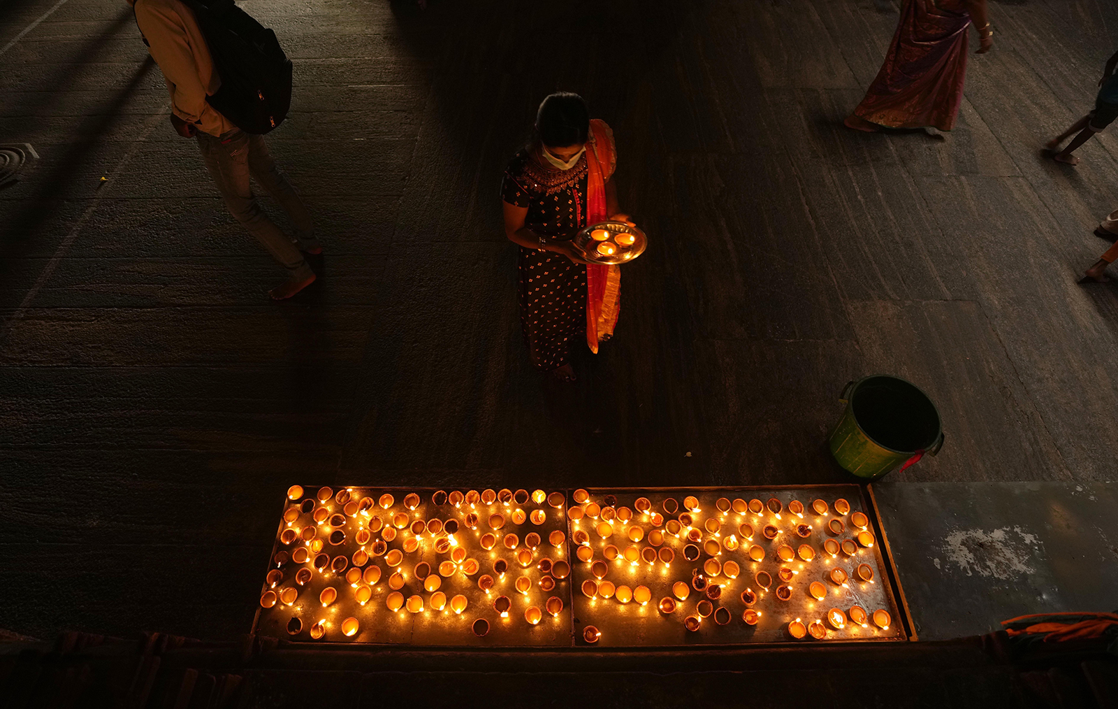 An ethnic Tamil woman prays holding a tray of oil lamps during Diwali, the Hindu festival of lights, in Colombo, Sri Lanka, Thursday, Nov. 4, 2021. Diwali is one of Hinduism's most important festivals. (AP Photo/Eranga Jayawardena)