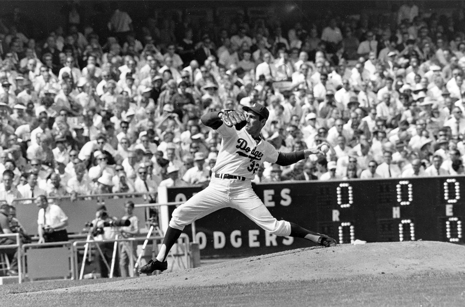 FILE - In this Oct. 6, 1966 file photo, Los Angeles Dodgers' Sandy Koufax pitches against the Baltimore Orioles in game two of the World Series baseball game in Los Angeles. In 1965, Koufax didn't pitch the Dodgers' Series opener at Minnesota because of Yom Kippur and lost to Jim Kaat the following day. Koufax pitched a four-hit shutout on three days' rest to win Game 5, then came back with a three-hit shutout on two days' rest to win Game 7. (AP Photo/File)