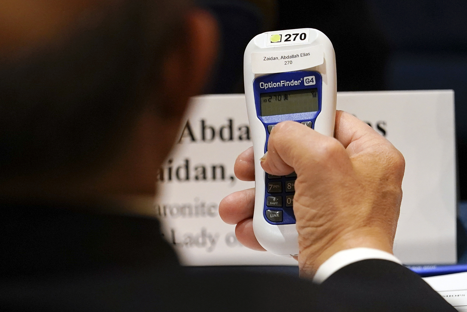 Bishop Abdallah Elias Zaidan, of Our Lady of Lebanon Maronite Catholic Church in Lewisville, Texas, holds his voting device during the Fall General Assembly meeting of the United States Conference of Catholic Bishops, Wednesday, Nov. 17, 2021, in Baltimore. (AP Photo/Julio Cortez)