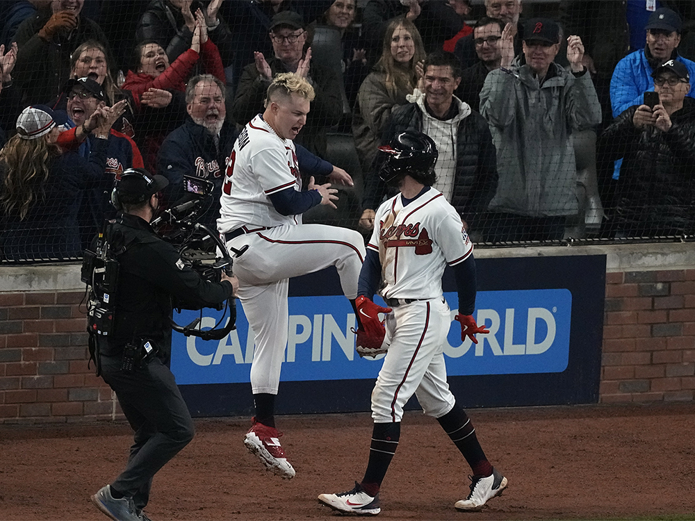 Atlanta Braves' Dansby Swanson, right, celebrates his home run with Joc Pederson during the seventh inning in Game 4 of baseball's World Series between the Houston Astros and the Atlanta Braves, Saturday, Oct. 30, 2021, in Atlanta. (AP Photo/John Bazemore)