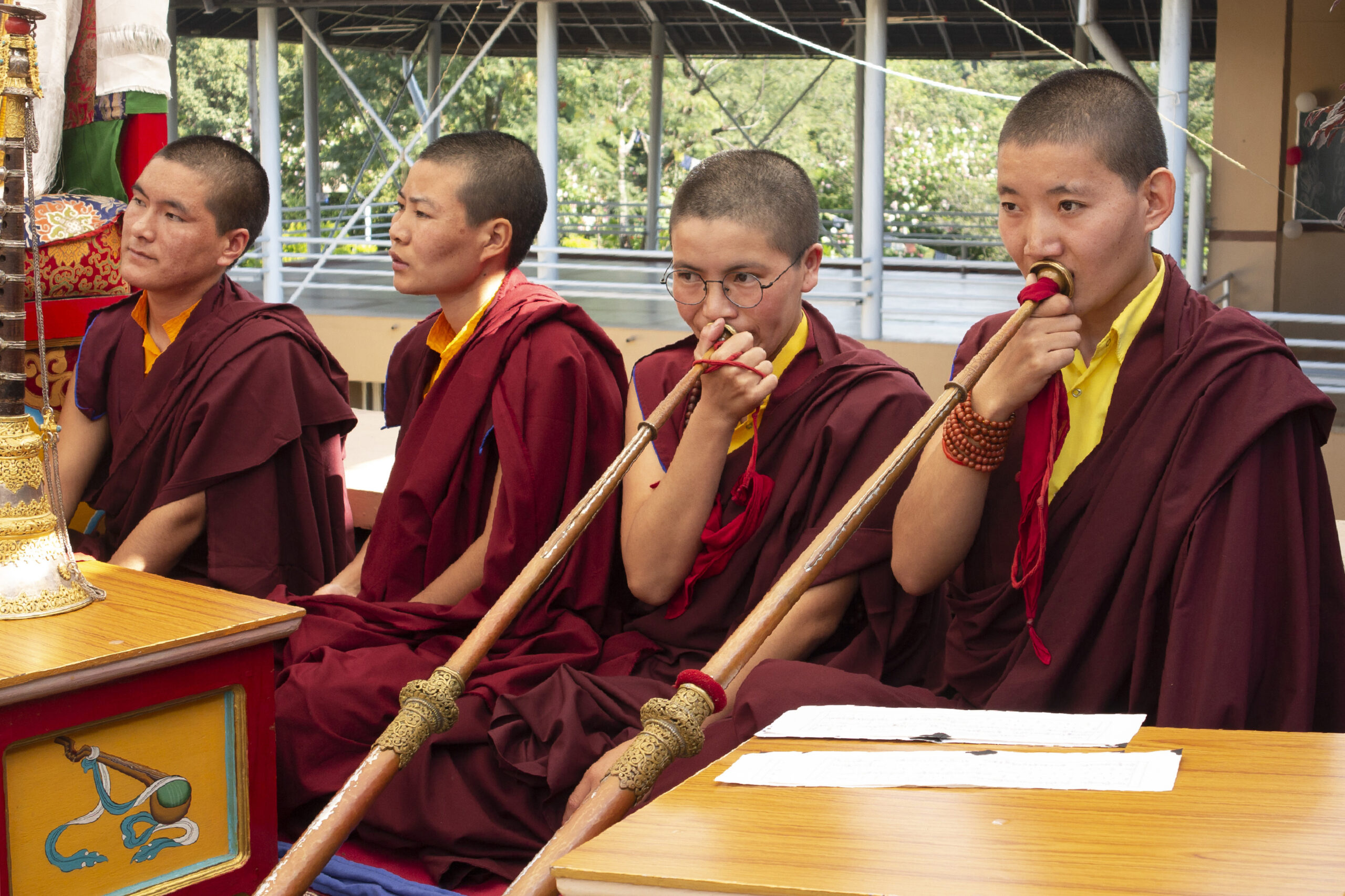 In this photo provided by the Dongyu Gatsal Ling nunnery, a group of nuns play a ritual instrument, the Tibetan longhorn, or dungchen, which are commonly used during ceremonies, at the nunnery in the state of Himachal Pradesh, India on Oct. 27, 2021. About 100 nuns live and study here. (Dongyu Gatsal Ling nunnery via AP)