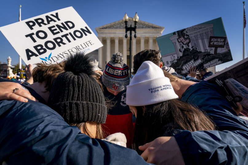 FILE - A group of anti-abortion protesters pray together in front of the U.S. Supreme Court, Dec. 1, 2021, in Washington, as the court hears arguments in a case from Mississippi, where a 2018 law would ban abortions after 15 weeks of pregnancy, well before viability. As the Supreme Court court weighs the future of the landmark 1973 Roe v. Wade decision, a resurgent anti-abortion movement is looking to press its advantage in state-by-state battles while abortion-rights supporters prepare to play defense. (AP Photo/Andrew Harnik, File)