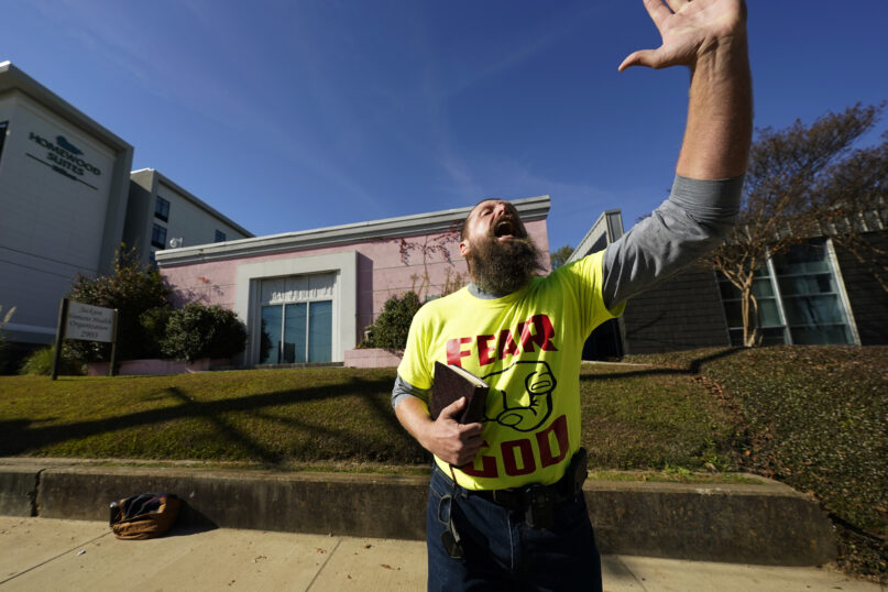 Allen Siders, an anti-abortion activist, preaches outside of the Jackson Women's Health Organization, a state-licensed abortion clinic in Jackson, Miss., Tuesday, Nov. 30, 2021. A small group of anti-abortion activists stood outside the clinic in an effort to dissuade patients from entering. On Wednesday, the U.S. Supreme Court will hear a case that directly challenges the constitutional right to an abortion established nearly 50 years ago. (AP Photo/Rogelio V. Solis)