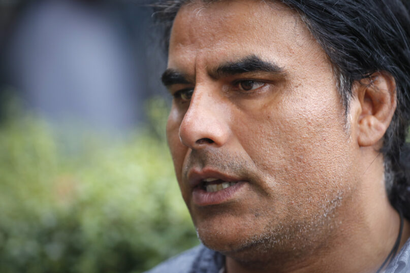 FILE - Abdul Aziz, a survivor of a mosque shooting speaks to Associated Press during an interview in Christchurch, New Zealand, on March 16, 2019. Aziz is one of two worshippers who at different times charged toward a gunman to try and stop his massacre were on Thursday, Dec. 16, 2021 each awarded New Zealand's highest honor for civilian bravery. (AP Photo/Vincent Thian, File)