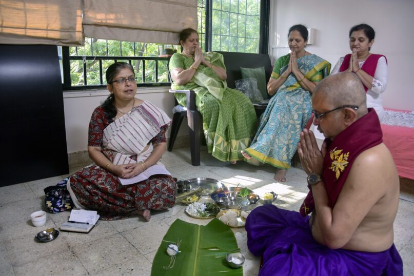 Manisha Shete, left, a practicing Hindu priest, performs posthumous rituals for her client's mother at a residence in Pune, India, Wednesday, Oct. 20, 2021. Shete, who first began to officiate at religious ceremonies in 2008, said demand is growing and “people have started accepting women priests.” (AP Photo/Abhijit Bhatlekar)