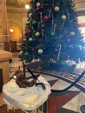 A baby Baphomet, brought by the The Satanic Temple of Illinois, is included in a holiday display in the Illinois statehouse rotunda in Springfield, Illinois, Monday, Dec. 20, 2021. Photo by Tanooki S. for The Satanic Temple of Illinois
