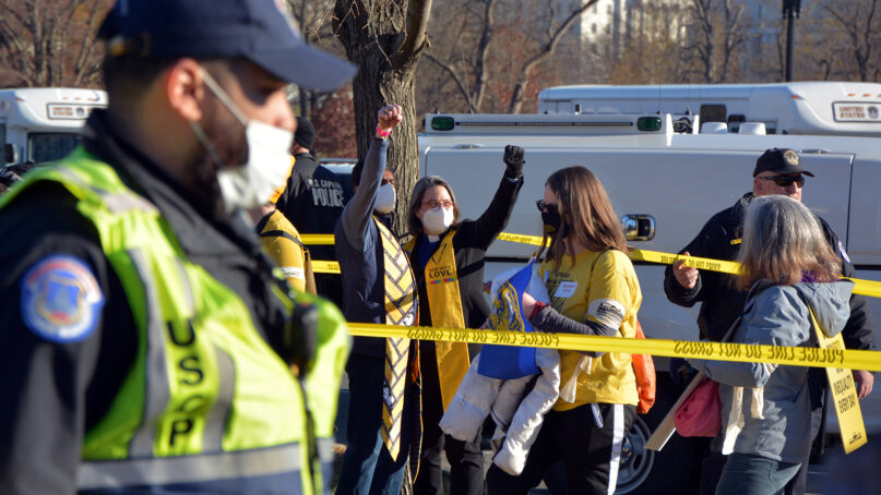 The Rev. Susan Frederick-Gray, center right, president of the Unitarian Universalist Association, and a colleague behind police tape after being arrested, Monday, Dec. 13, 2021. RNS photo by Jack Jenkins