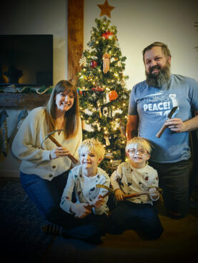 Mike Martin, founder of RAW Tools, and his family hold garden tools made from donated guns in a Christmas card. Courtesy photo