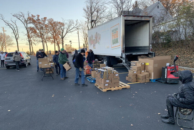 Volunteers unload a Northern Illinois Food Bank truck for distribution in a parking lot of St. Anne’s Episcopal Church in Woodstock, Illinois, Nov. 22, 2021. RNS photo by Bob Smietana