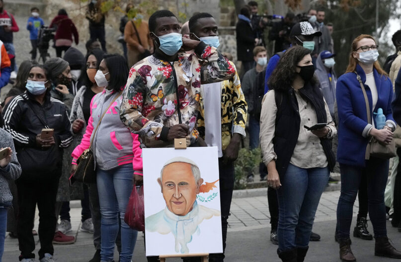 People await Pope Francis for an ecumenical prayer with migrants at the Parish Church of the Holy Cross in Nicosia, Cyprus, Friday, Dec. 3, 2021. Francis is on a five-day trip to Cyprus and Greece and drawing attention once again to his call for Europe to welcome migrants. (AP Photo/Petros Karadjias)