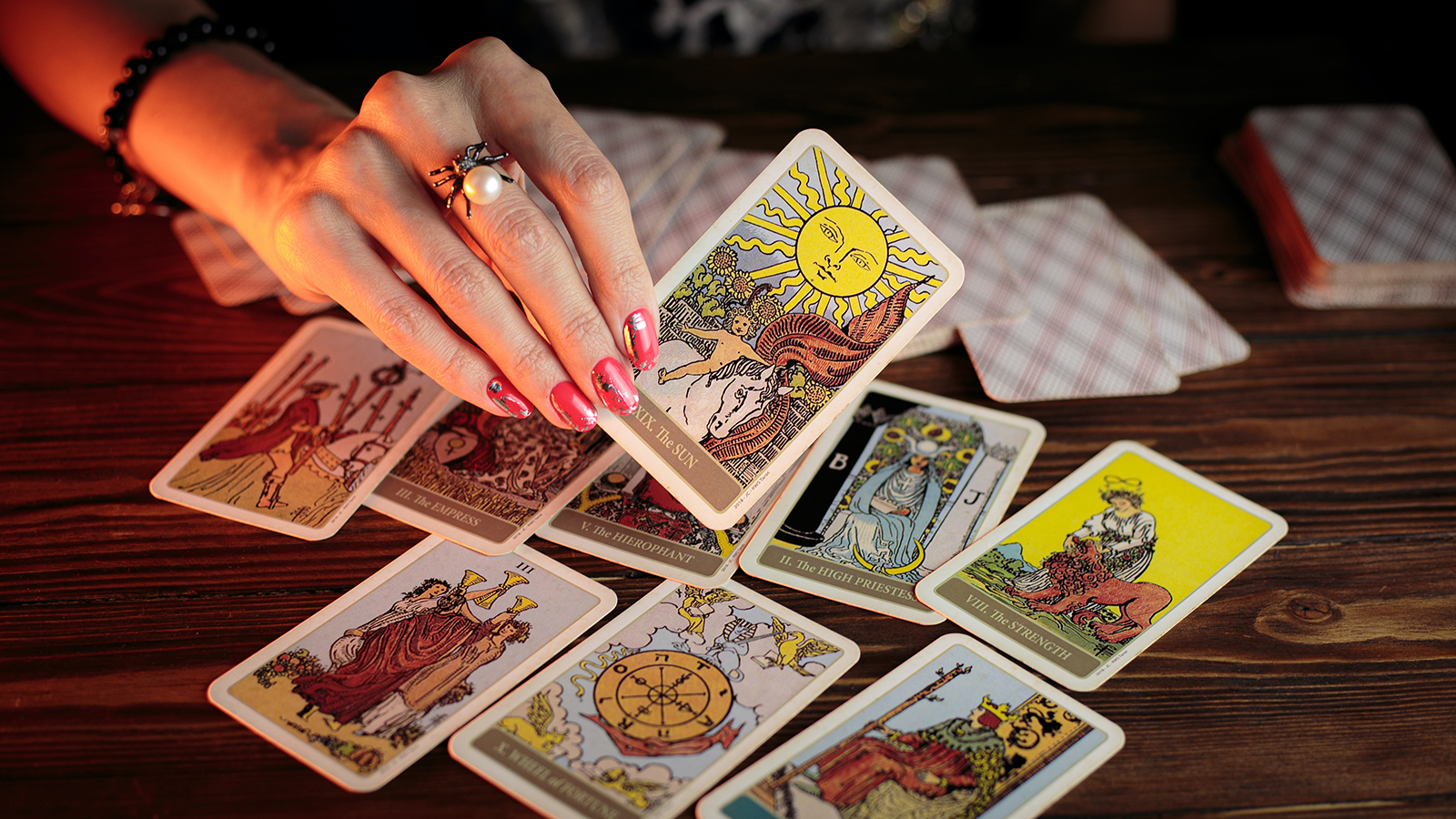 A woman displays tarot cards. Photo by Petr Sidorov/Unsplash/Creative Commons