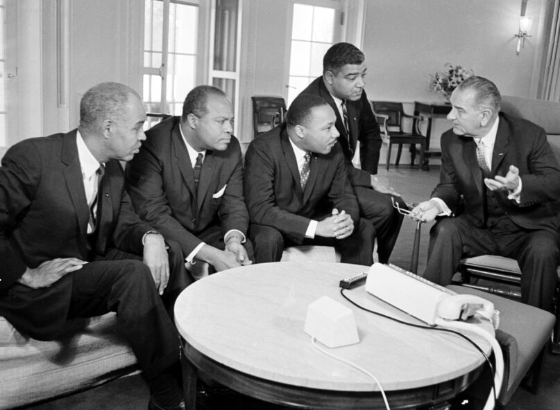 President Lyndon B. Johnson, right, talks with Martin Luther King Jr. and other civil rights leaders in his White House office in Washington, D.C., Jan. 18, 1964. (AP Photo)