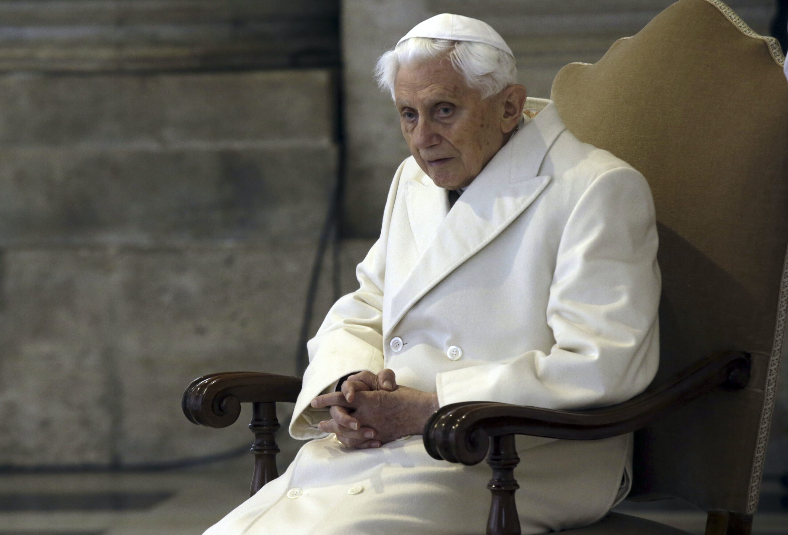 Pope Emeritus Benedict XVI sits in St. Peter's Basilica on Dec. 8, 2015. A long-awaited report on sexual abuse faulted his handling of four cases. (AP Photo/Gregorio Borgia)